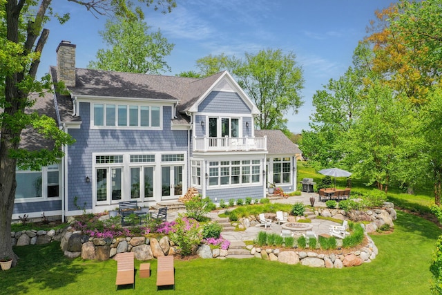 46815 Elizabeth Ln, Decatur, MI 49045 - back of house with a fire pit, a balcony, a chimney, and a patio area