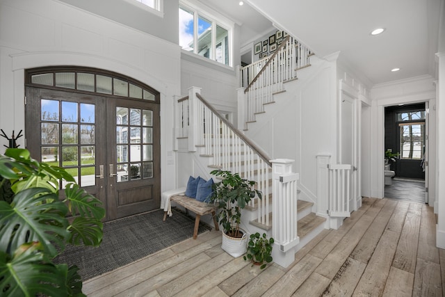 46815 Elizabeth Ln, Decatur, MI 49045 - entrance foyer featuring healthy amount of natural light, french doors, stairs, light wood-style floors, and a decorative wall