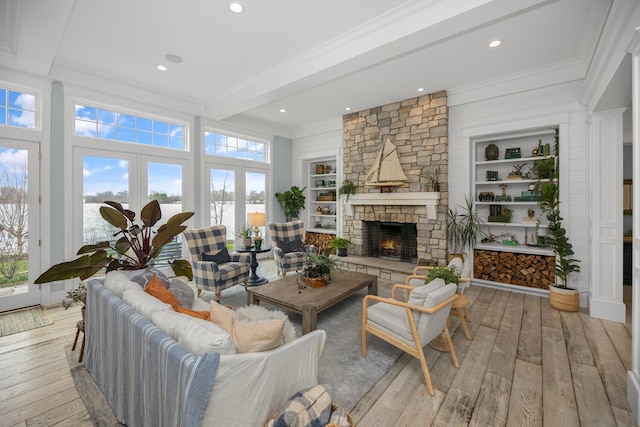 46815 Elizabeth Ln, Decatur, MI 49045 - living area with beam ceiling, healthy amount of natural light, light wood-style flooring, a stone fireplace, and crown molding