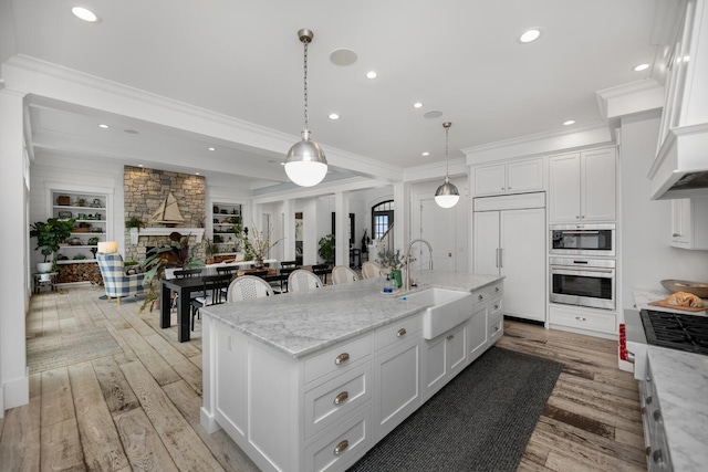 46815 Elizabeth Ln, Decatur, MI 49045 - kitchen featuring a sink, paneled fridge, light wood-style floors, white cabinetry, and recessed lighting