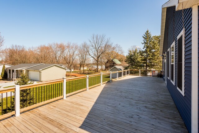 deck featuring an outdoor structure and a lawn