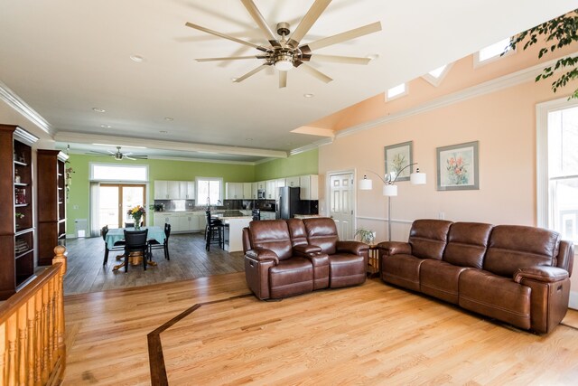 living area with a ceiling fan, light wood-type flooring, crown molding, and recessed lighting