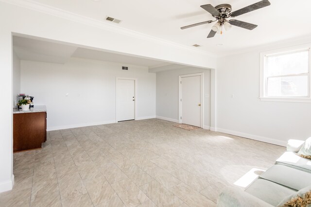 unfurnished living room featuring ornamental molding, a ceiling fan, and baseboards