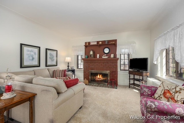 living room featuring a wealth of natural light, carpet flooring, and a fireplace