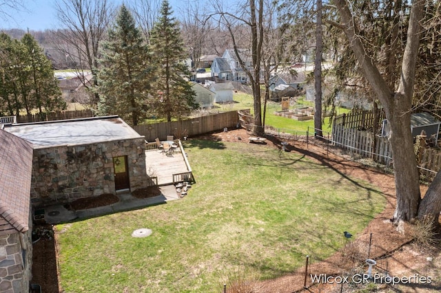 view of yard featuring a fenced backyard and a residential view