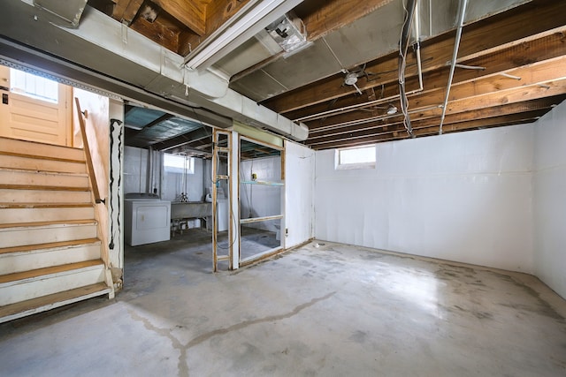 basement featuring washer / dryer, a sink, and stairway
