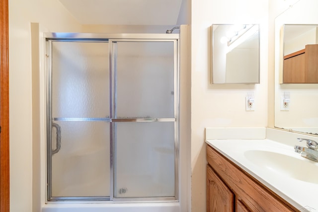 bathroom with a shower stall and vanity