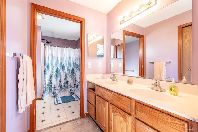 bathroom with tile patterned floors, a shower with curtain, a sink, and double vanity