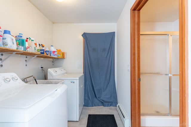 washroom featuring light tile patterned floors, washer and clothes dryer, laundry area, and a baseboard radiator