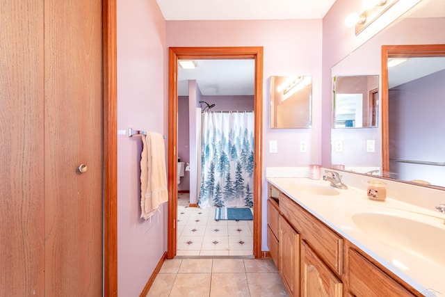 full bath featuring curtained shower, baseboards, a sink, and double vanity