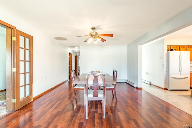 dining space featuring ceiling fan, baseboards, dark wood-style flooring, and a baseboard radiator