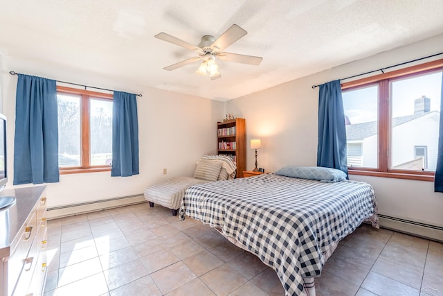bedroom featuring light tile patterned floors, ceiling fan, and a baseboard radiator