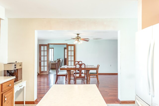 dining area featuring ceiling fan, baseboards, french doors, and wood finished floors