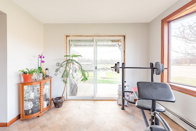 workout room featuring plenty of natural light and baseboards