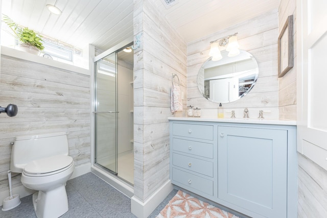 full bathroom with a shower stall, toilet, vanity, and tile patterned floors