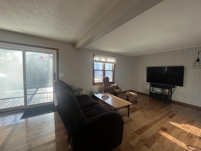 303 Sydelle Ave, Kalamazoo, MI 49006 - living room with wood finished floors, beamed ceiling, and a textured ceiling
