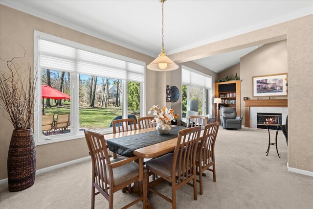 4435 Driftwood Dr, Commerce Twp, MI 48382 - dining area featuring light carpet, a tile fireplace, ornamental molding, and vaulted ceiling