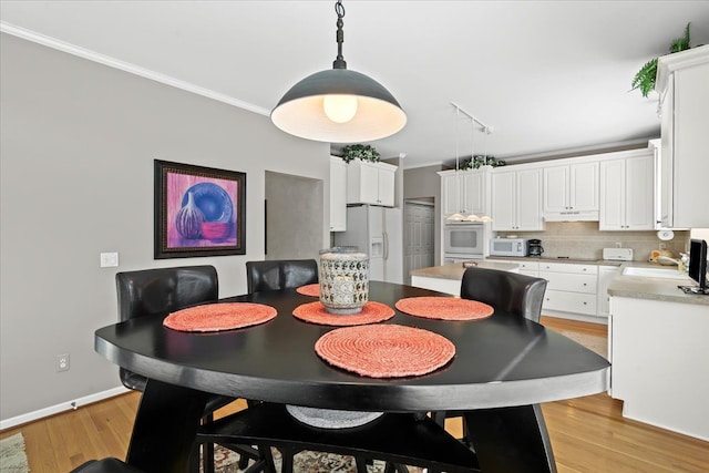 4435 Driftwood Dr, Commerce Twp, MI 48382 - dining area with ornamental molding and light wood-style flooring