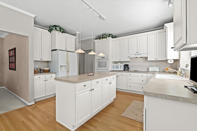 4435 Driftwood Dr, Commerce Twp, MI 48382 - kitchen with white appliances, a center island, backsplash, white cabinetry, and light wood-style flooring