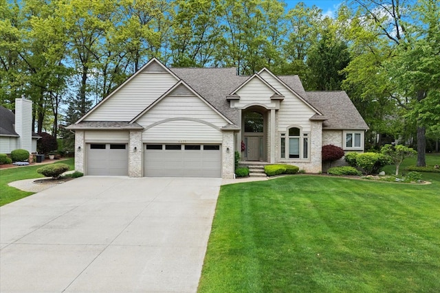 4435 Driftwood Dr, Commerce Twp, MI 48382 - traditional-style home with concrete driveway, a front yard, brick siding, and roof with shingles