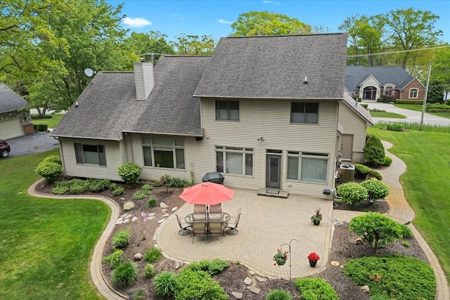 4435 Driftwood Dr, Commerce Twp, MI 48382 - back of house with a chimney, a yard, a patio area, and roof with shingles