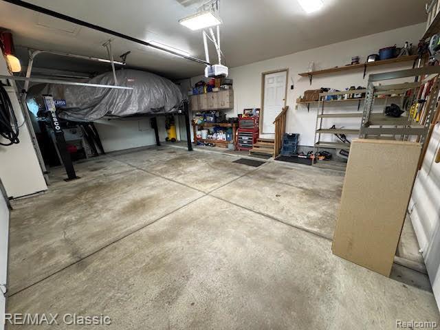 4435 Driftwood Dr, Commerce Twp, MI 48382 - garage featuring a garage door opener