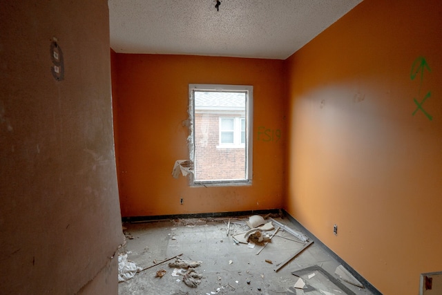 spare room with a textured ceiling