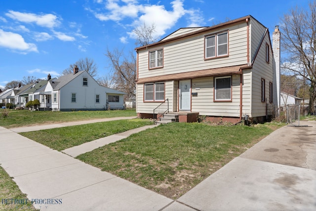 14725 Agnes Ave, Eastpointe, MI 48021 - view of front of home featuring a chimney and a front yard