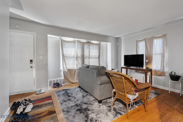 14725 Agnes Ave, Eastpointe, MI 48021 - living room with wood finished floors, visible vents, and baseboards