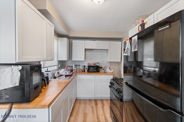 14725 Agnes Ave, Eastpointe, MI 48021 - kitchen with light wood finished floors, butcher block countertops, and white cabinetry
