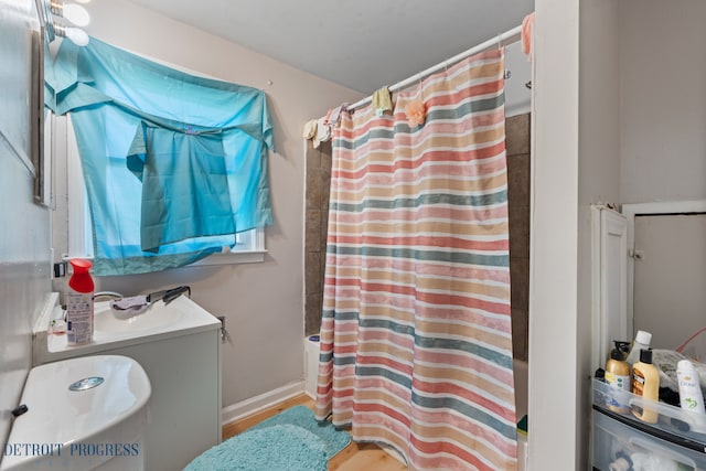 14725 Agnes Ave, Eastpointe, MI 48021 - bathroom with a shower with curtain, wood finished floors, and a sink