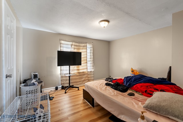 14725 Agnes Ave, Eastpointe, MI 48021 - bedroom with baseboards, wood finished floors, and a textured ceiling