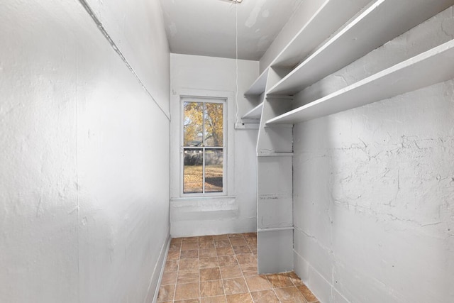 spacious closet with stone finish flooring