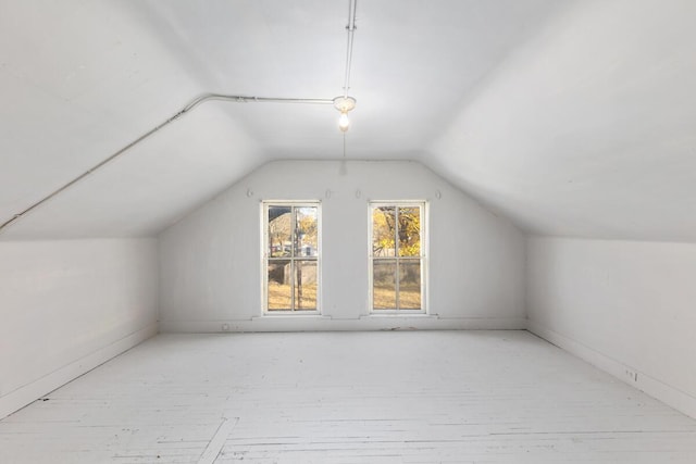 bonus room with vaulted ceiling and hardwood / wood-style flooring