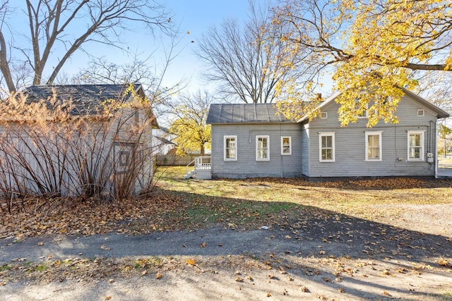view of home's exterior with an outdoor structure