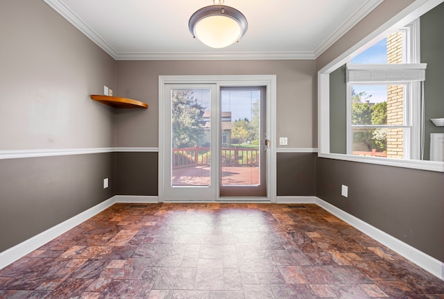 doorway to outside with baseboards, ornamental molding, and stone tile flooring