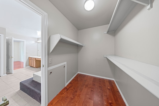 walk in closet featuring wood finished floors