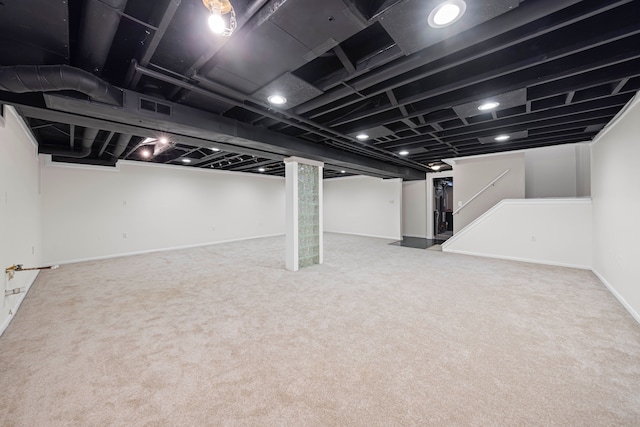 finished below grade area featuring baseboards, carpet flooring, and visible vents