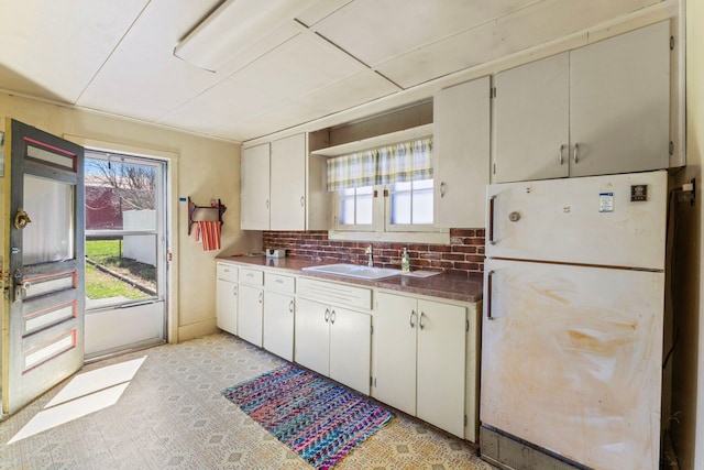 3931 S Shore Dr, Lapeer, MI 48446 - kitchen featuring backsplash, freestanding refrigerator, a wealth of natural light, and a sink