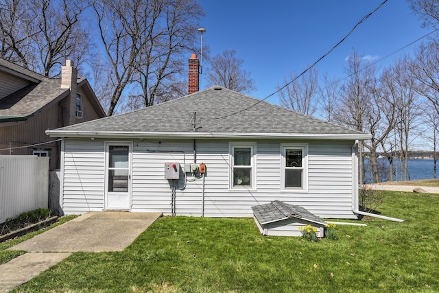 3931 S Shore Dr, Lapeer, MI 48446 - back of house featuring a lawn, fence, and roof with shingles