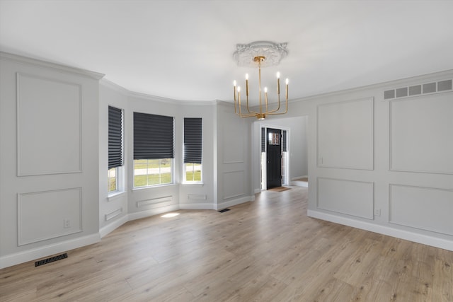 unfurnished dining area with a chandelier, a decorative wall, and visible vents