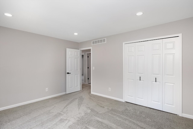 unfurnished bedroom with baseboards, visible vents, recessed lighting, and carpet flooring