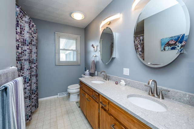 1601 Barbara Ann Dr, Stevensville, MI 49127 - bathroom featuring double vanity, visible vents, toilet, and a sink