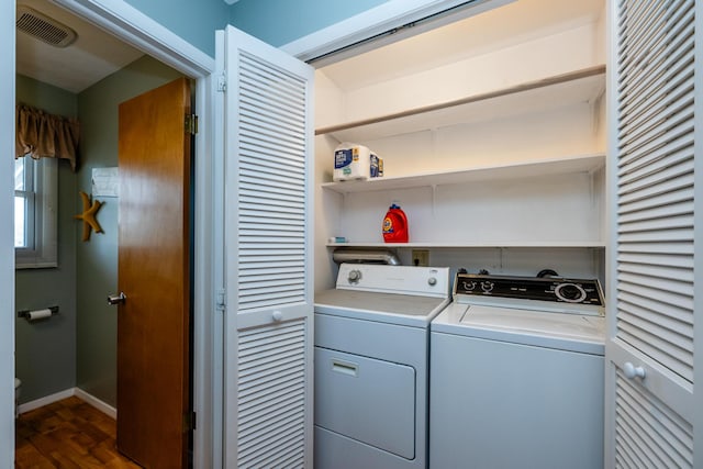 1601 Barbara Ann Dr, Stevensville, MI 49127 - washroom with washer and clothes dryer, dark wood finished floors, baseboards, visible vents, and laundry area