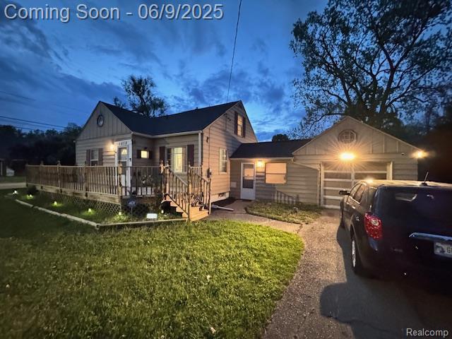 3018 W Dartmouth St, Flint, MI 48504 - view of home's exterior with a garage, a deck, and a lawn