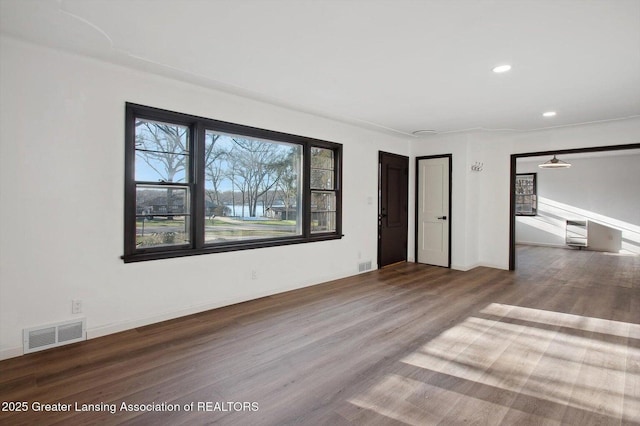 unfurnished living room featuring wood finished floors, visible vents, and recessed lighting