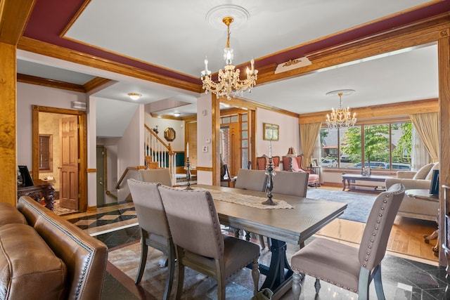 dining area with granite finish floor, stairway, ornamental molding, and a notable chandelier