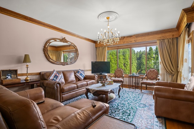 living room with an inviting chandelier, ornamental molding, and wood finished floors
