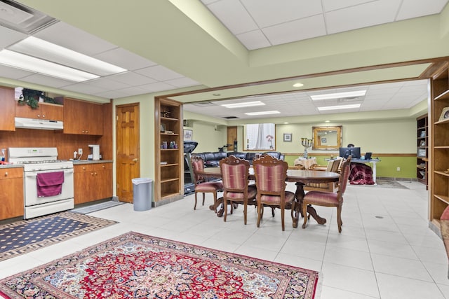 dining area featuring visible vents, a drop ceiling, and light tile patterned floors