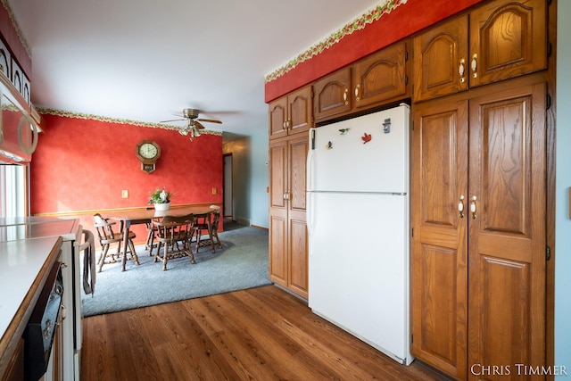 15230 Van Buren St Unit B, Holland, MI 49424 - kitchen with brown cabinetry, ceiling fan, dark wood-type flooring, stove, and freestanding refrigerator